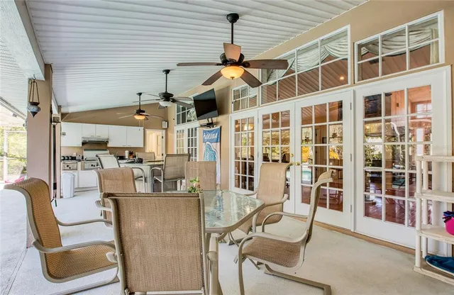 a kitchen with white cabinets and appliances