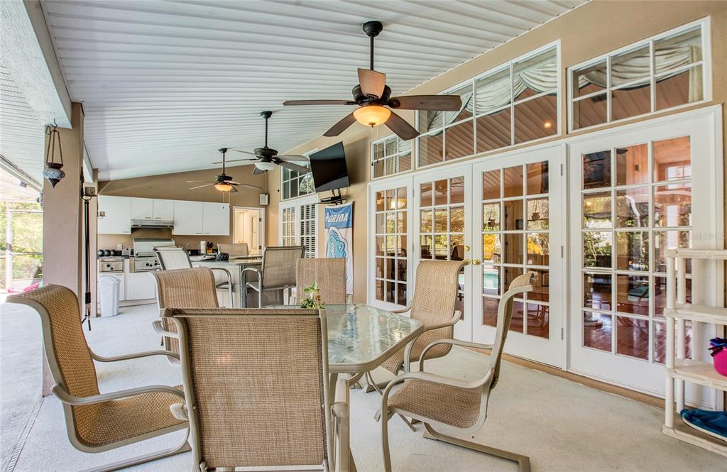 4901 Hallstead Way Tampa, FL 33647 - Photo 38 of 47 a living room with furniture a flat screen tv and floor to ceiling windows