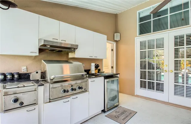 a kitchen with stainless steel appliances granite countertop a stove and a refrigerator