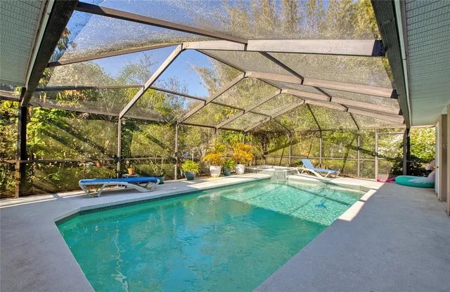 a swimming pool with outdoor seating and yard