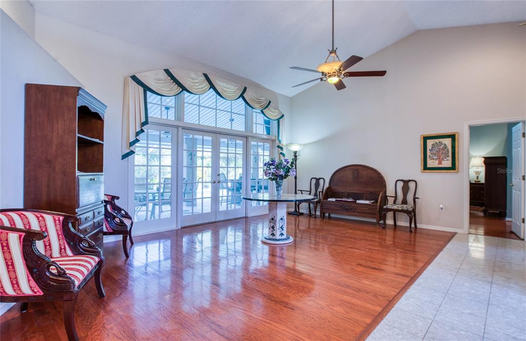 4901 Hallstead Way Tampa, FL 33647 - Photo 6 of 47 a living room with furniture a dining table and a chandelier