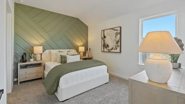 a bedroom with a bed and a painting on the wall