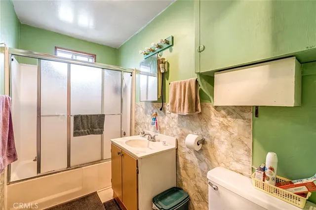 a bathroom with a sink mirror vanity and toilet
