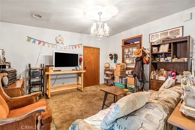 a view of a livingroom with furniture and a flat screen tv