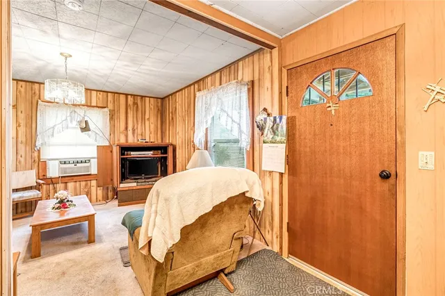 a living room with furniture a fireplace and a large window