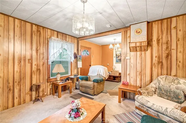 a living room with furniture or couch and a chandelier