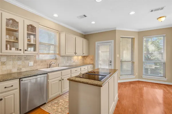 a kitchen that has a sink and a stove in it