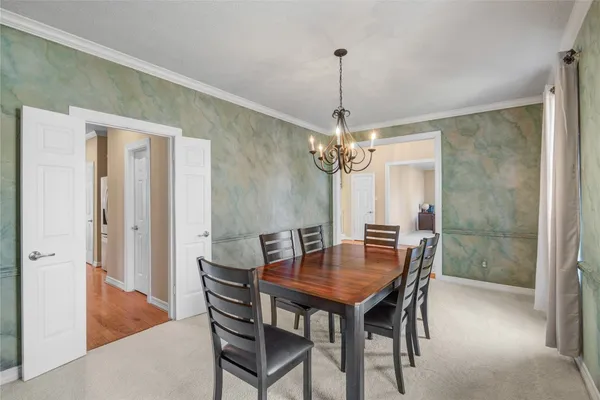 a view of a dining room with a table and chairs