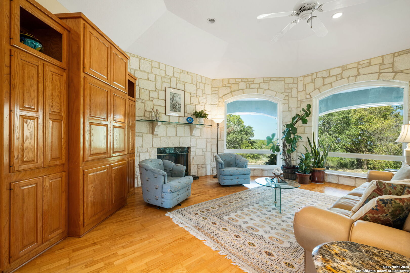 305 Spanish Pass Road Boerne, TX 78006 - Photo 18 of 105 a living room with furniture fireplace and a large window