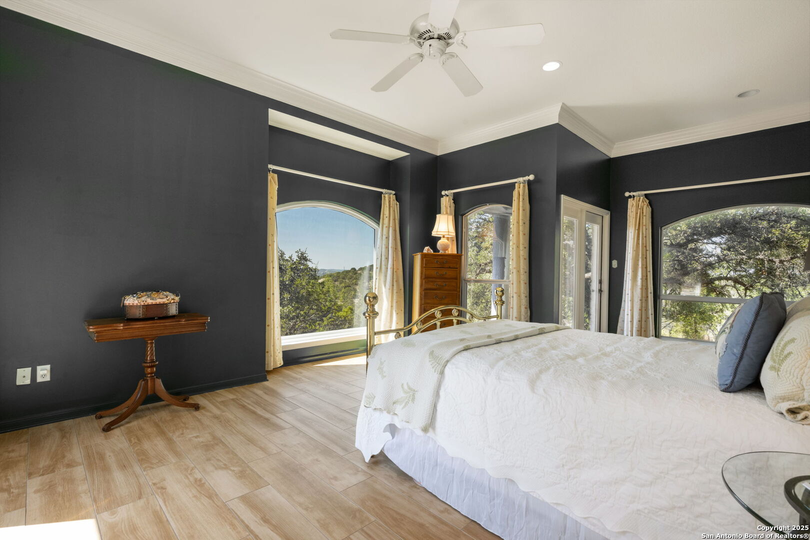 305 Spanish Pass Road Boerne, TX 78006 - Photo 21 of 105 a bedroom with a bed and glass windows