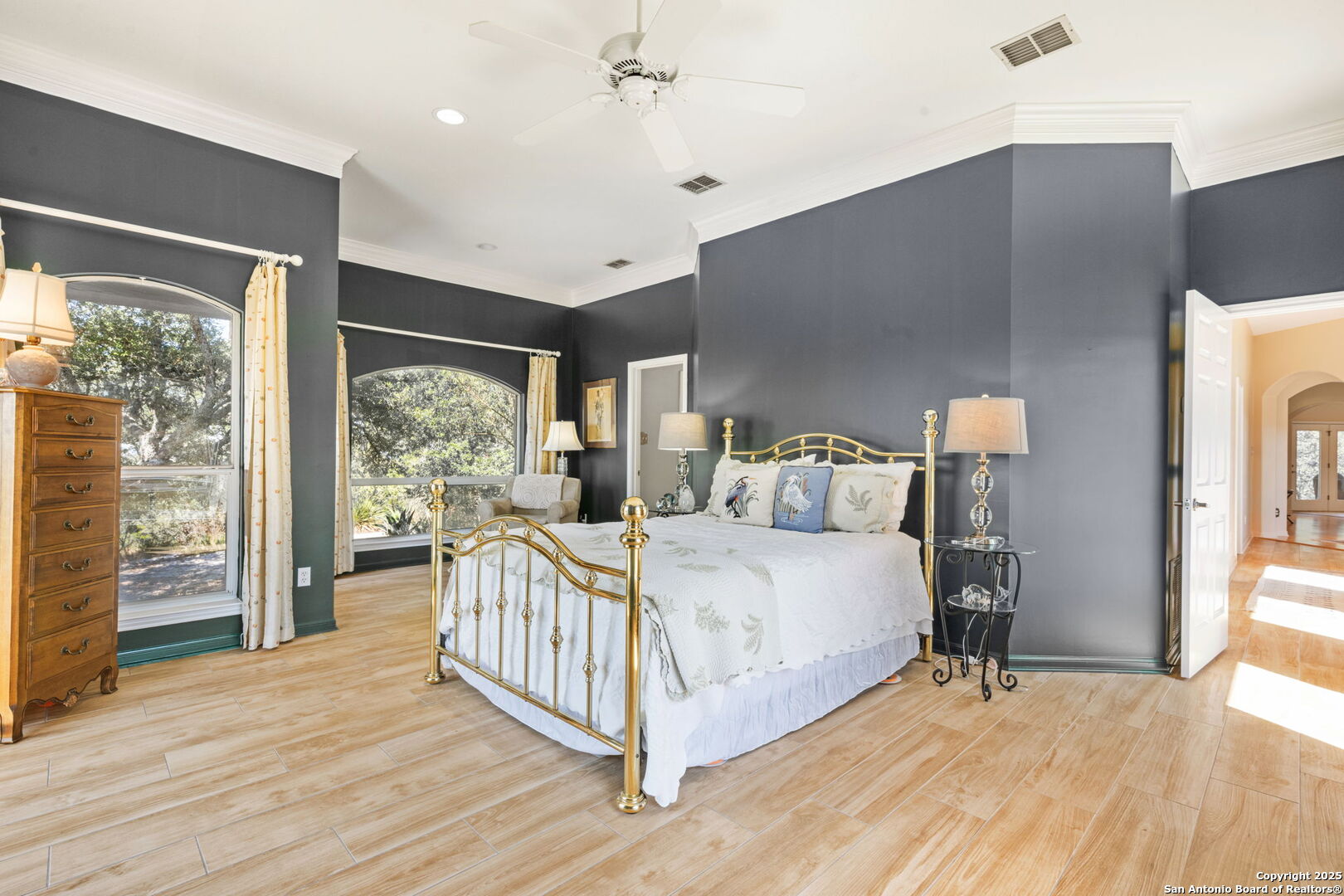 305 Spanish Pass Road Boerne, TX 78006 - Photo 23 of 105 a bedroom with a bed and a large window with outer view