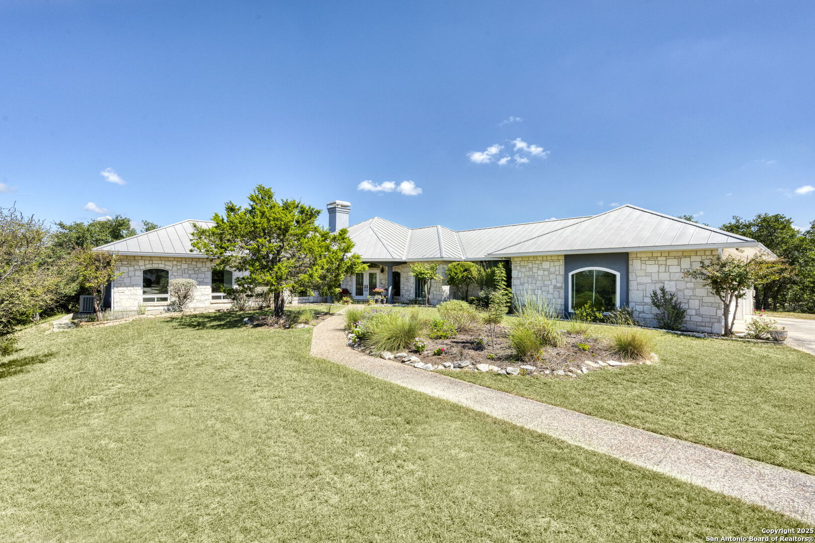 305 Spanish Pass Road Boerne, TX 78006 - Photo 89 of 105 a front view of a house with a yard and garage