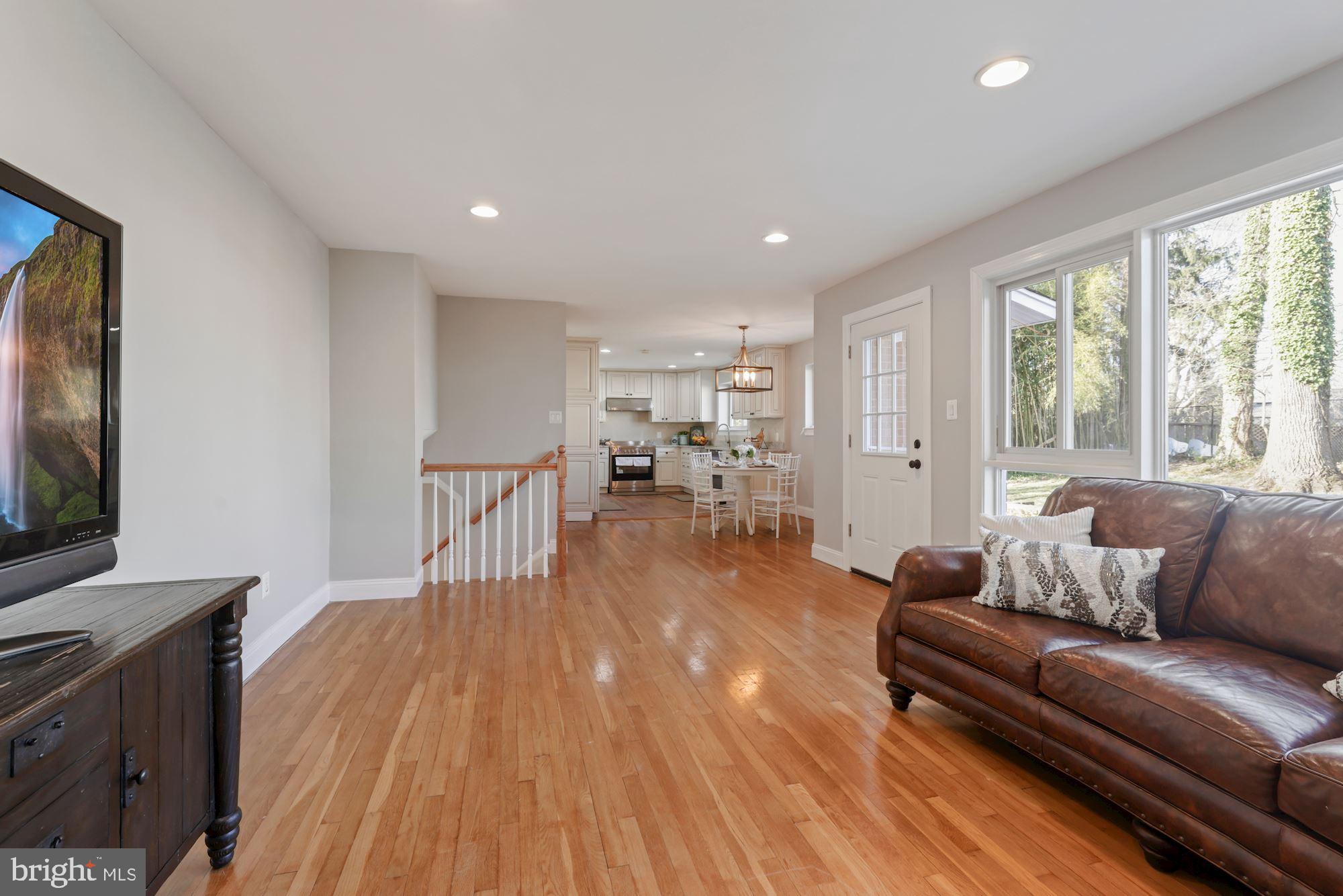 7716 Beech Tree Road Bethesda, MD 20817 - Photo 26 of 49 a living room with furniture and a flat screen tv