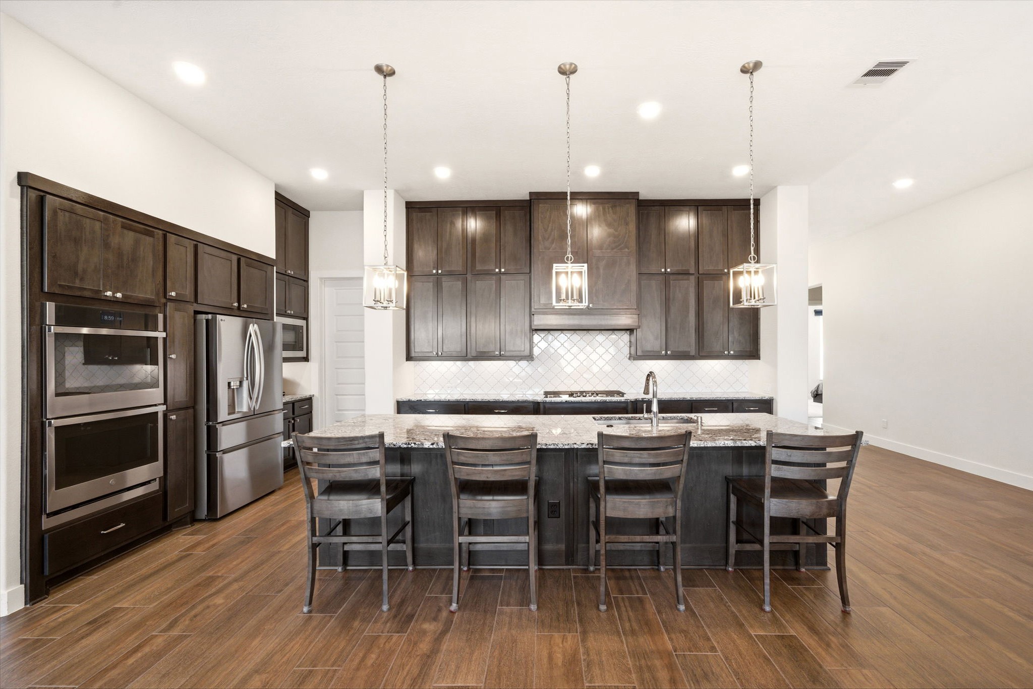 28811 Ember Crest Lane Fulshear, TX 77441 - Photo 3 of 47 a kitchen with a table chairs refrigerator and microwave