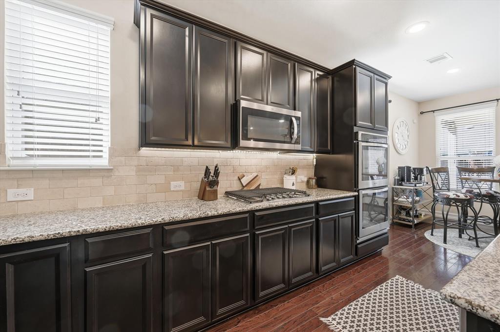 824 Pinnacle Ridge Road Fort Worth, TX 76052 - Photo 15 of 40 a kitchen with stainless steel appliances granite countertop a sink stove microwave and refrigerator