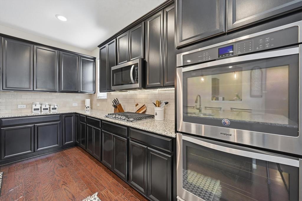 824 Pinnacle Ridge Road Fort Worth, TX 76052 - Photo 17 of 40 a kitchen with stainless steel appliances granite countertop a sink and a stove