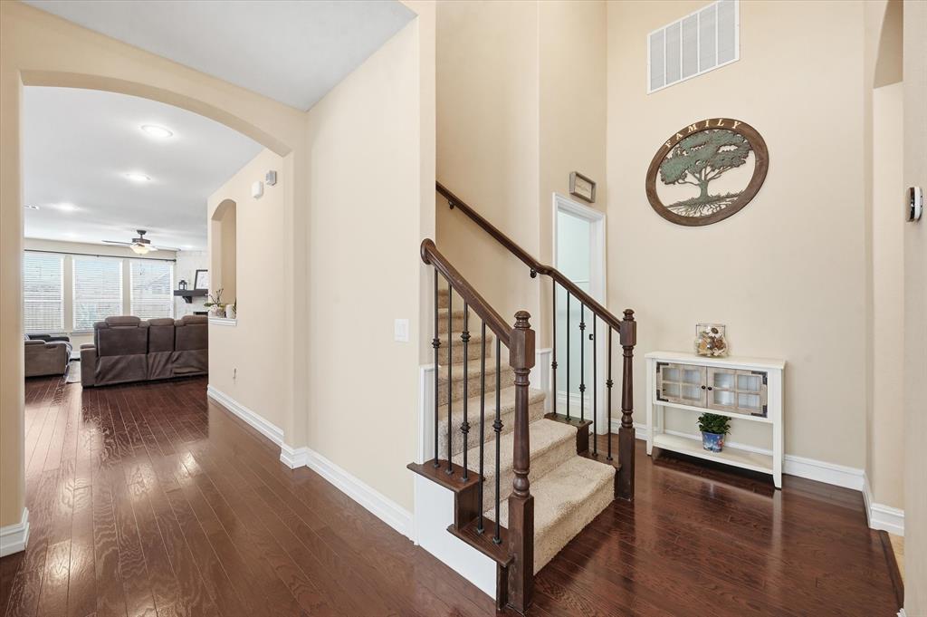 824 Pinnacle Ridge Road Fort Worth, TX 76052 - Photo 19 of 40 a view of livingroom with furniture wooden floor and a clock