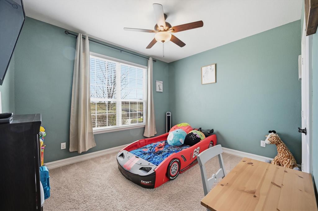 824 Pinnacle Ridge Road Fort Worth, TX 76052 - Photo 20 of 40 a bedroom with a bed and a window