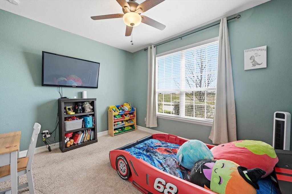 824 Pinnacle Ridge Road Fort Worth, TX 76052 - Photo 21 of 40 a bedroom with furniture and a window