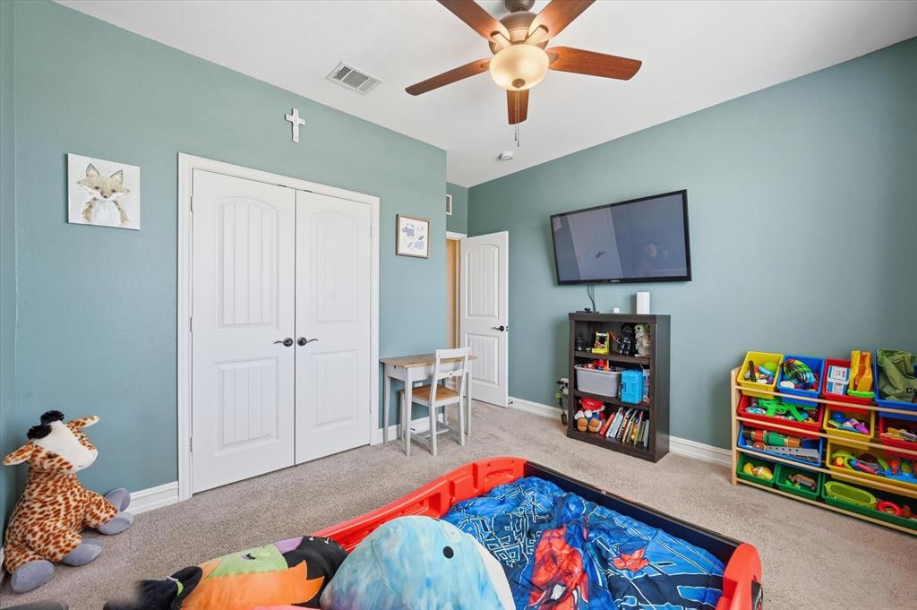 824 Pinnacle Ridge Road Fort Worth, TX 76052 - Photo 22 of 40 a bed room with a bed and a baby bed