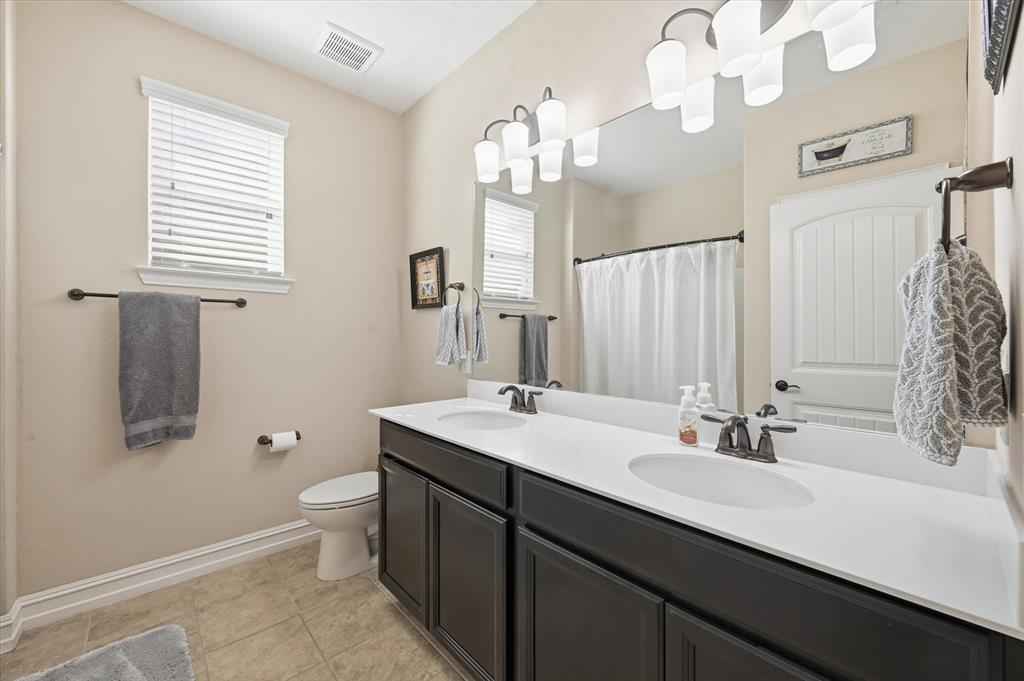 824 Pinnacle Ridge Road Fort Worth, TX 76052 - Photo 23 of 40 a bathroom with a sink double vanity granite and a mirror