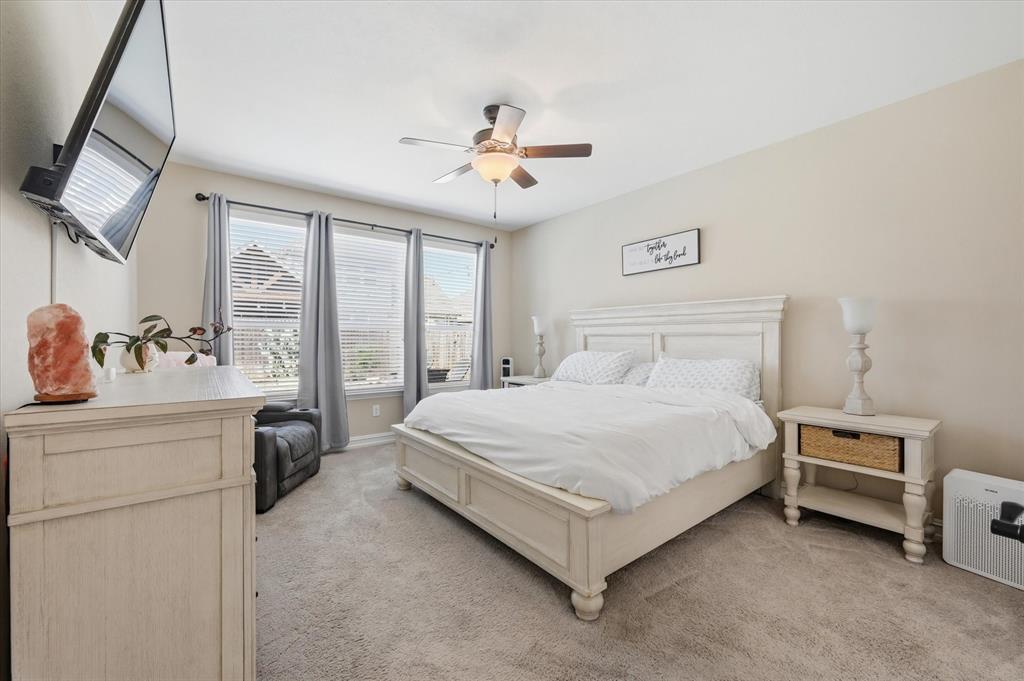 824 Pinnacle Ridge Road Fort Worth, TX 76052 - Photo 26 of 40 a bed room with a bed and a chandelier