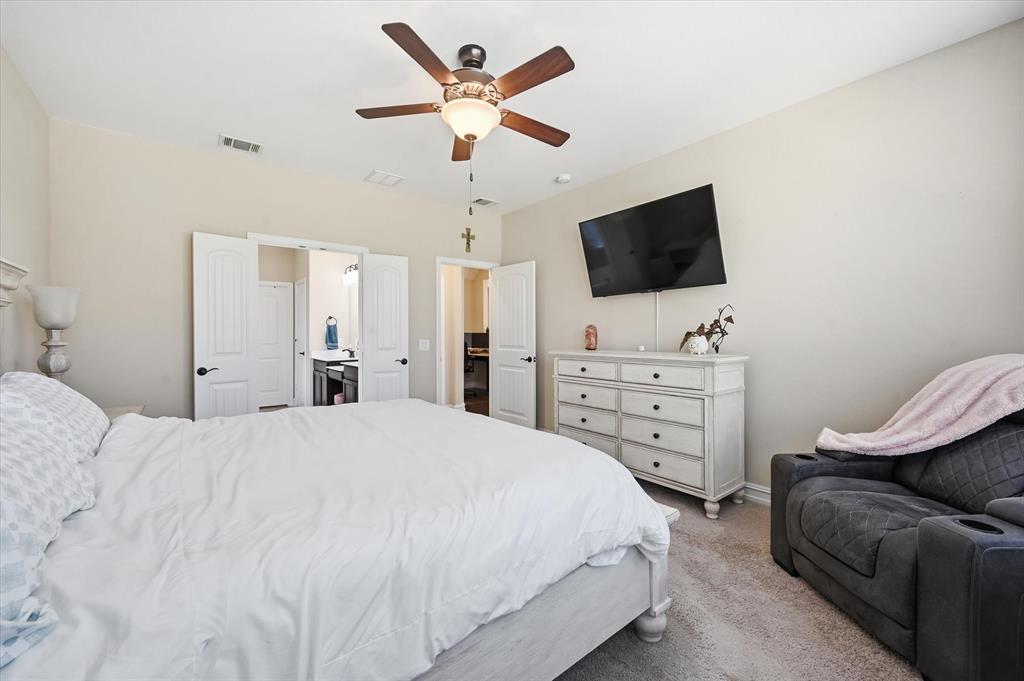 824 Pinnacle Ridge Road Fort Worth, TX 76052 - Photo 27 of 40 a bedroom with a bed a flat screen tv and a couch