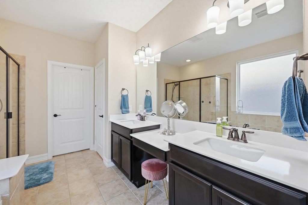 824 Pinnacle Ridge Road Fort Worth, TX 76052 - Photo 30 of 40 a en suite bathroom with a double vanity sink a mirror and shower