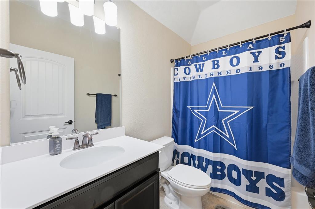 824 Pinnacle Ridge Road Fort Worth, TX 76052 - Photo 35 of 40 a bathroom with a sink a toilet and a mirror