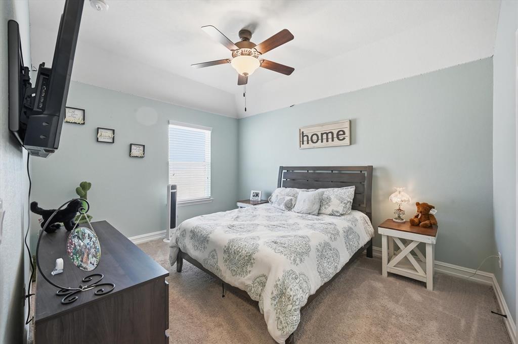 824 Pinnacle Ridge Road Fort Worth, TX 76052 - Photo 36 of 40 a bedroom with a bed and a chandelier