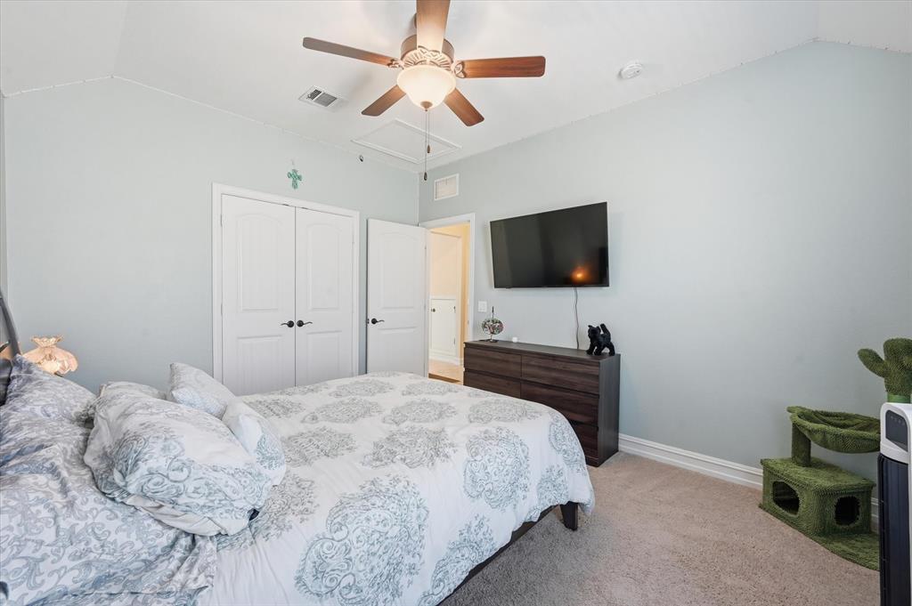 824 Pinnacle Ridge Road Fort Worth, TX 76052 - Photo 38 of 40 a bedroom with a bed window and a flat screen tv
