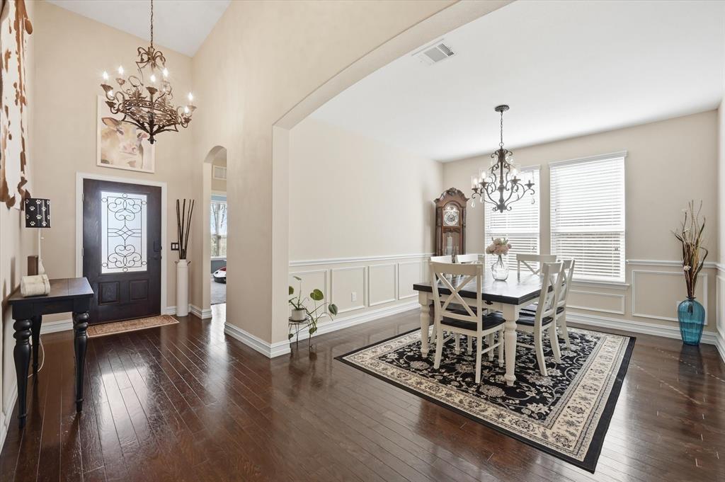 824 Pinnacle Ridge Road Fort Worth, TX 76052 - Photo 5 of 40 a view of a dining room with furniture wooden floor and chandelier