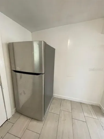 a view of a refrigerator in a kitchen