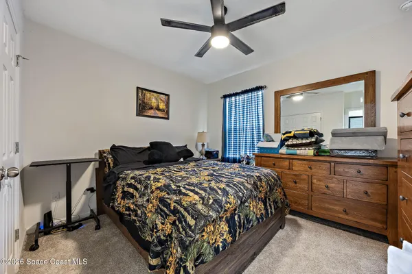 a bedroom with a bed and a dresser