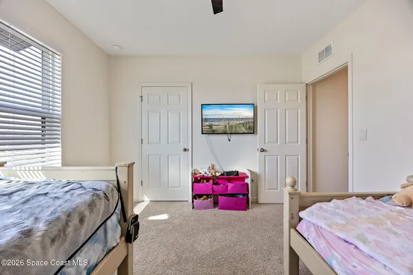a bedroom with a bed and a tv