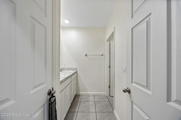 a bathroom with a granite countertop sink two washing machine and a shower