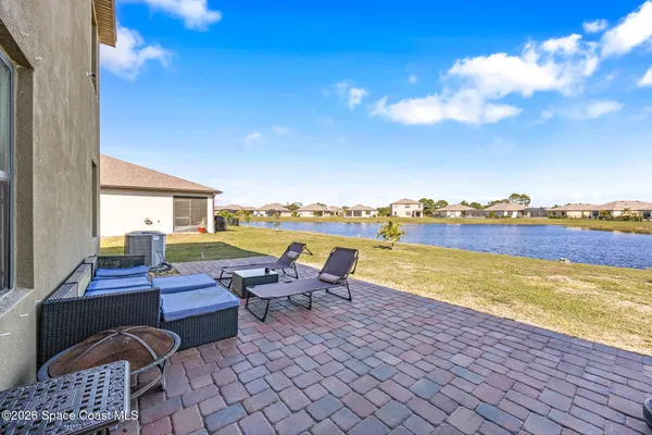 a view of a patio with lawn chairs