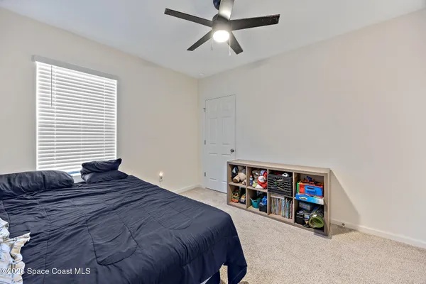 a bedroom with a bed a baby and a chandelier