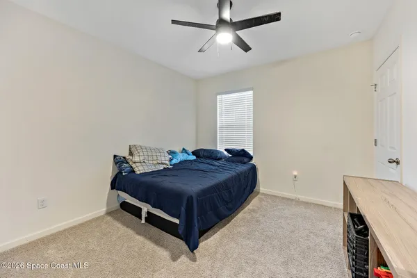 a room with a bed and a chandelier