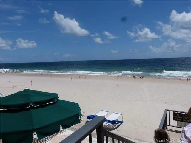 a view of a room with table and chairs