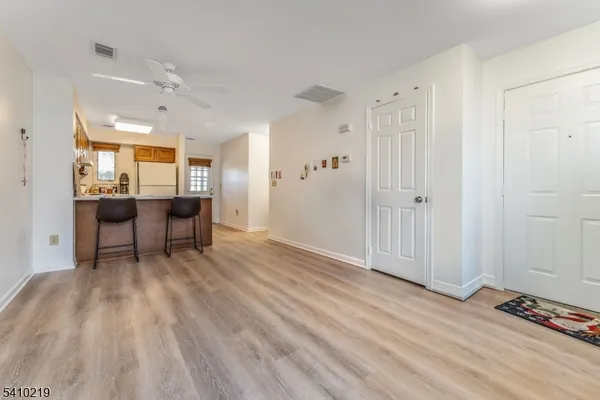 a view of a room with wooden floor and furniture