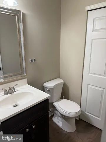 a white toilet sitting next to a bathroom sink