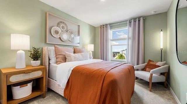 a bedroom with a bed and a large window