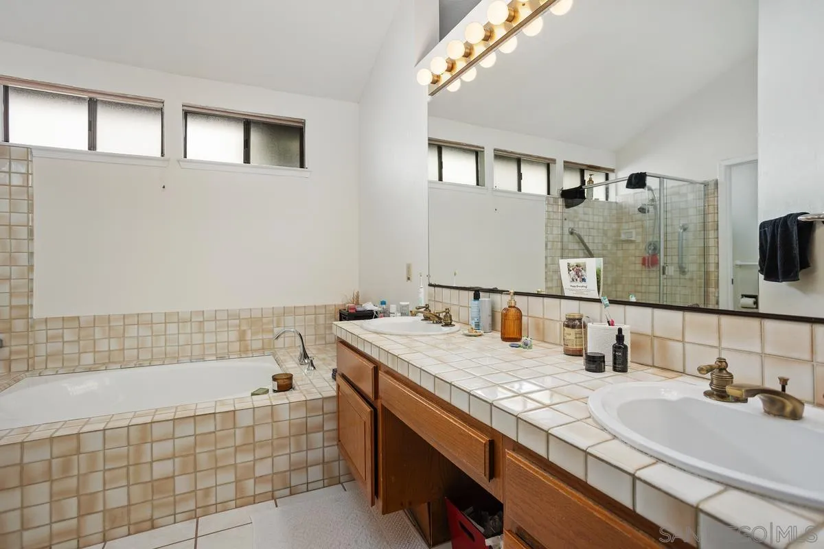 15089 Tierra Alta Del Mar, CA 92014 - Photo 14 of 25 a bathroom with a tub sink and mirror