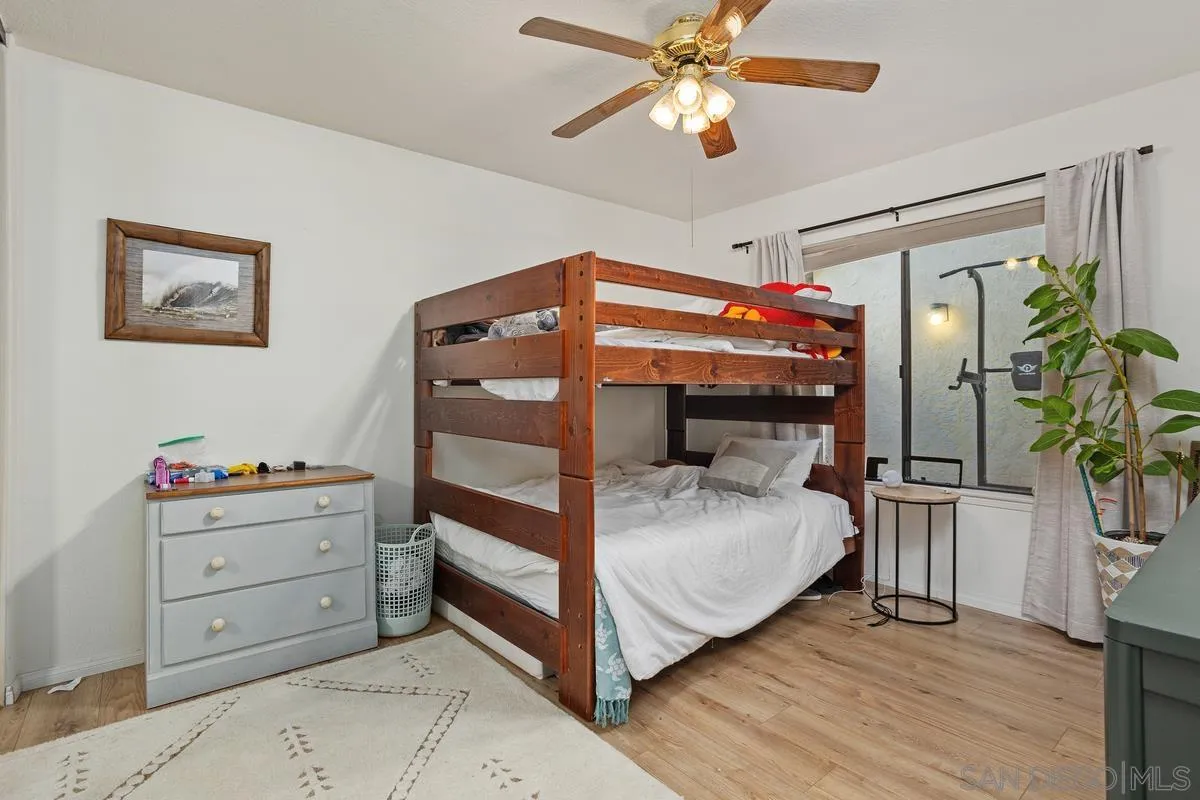 15089 Tierra Alta Del Mar, CA 92014 - Photo 17 of 25 a bedroom with a bed and a chandelier