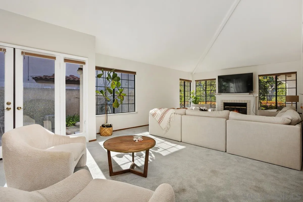 15089 Tierra Alta Del Mar, CA 92014 - Photo 7 of 25 a living room with furniture a fireplace and a flat screen tv