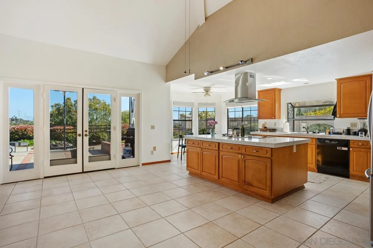 15089 Tierra Alta Del Mar, CA 92014 - Photo 9 of 25 a large white kitchen with a large window