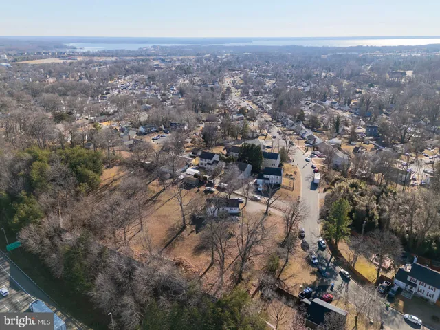 an aerial view of house with yard and mountain view in back