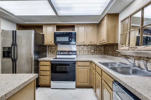 a kitchen with a sink stove and refrigerator