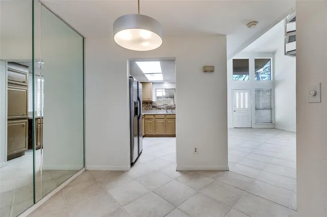 a view of kitchen with refrigerator and window